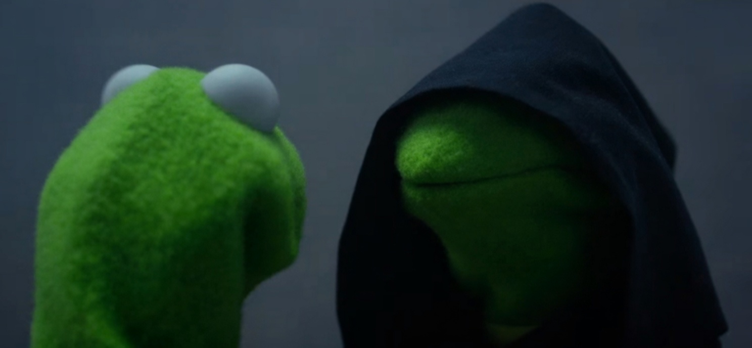 Two green frog puppets face each other against a plain dark gray background. The left puppet is a regular bright-green Kermit shown from the back/side with large white eyes. The right puppet is an identical green Kermit wearing a black hooded cloak that shadows its face, looking toward the left puppet.