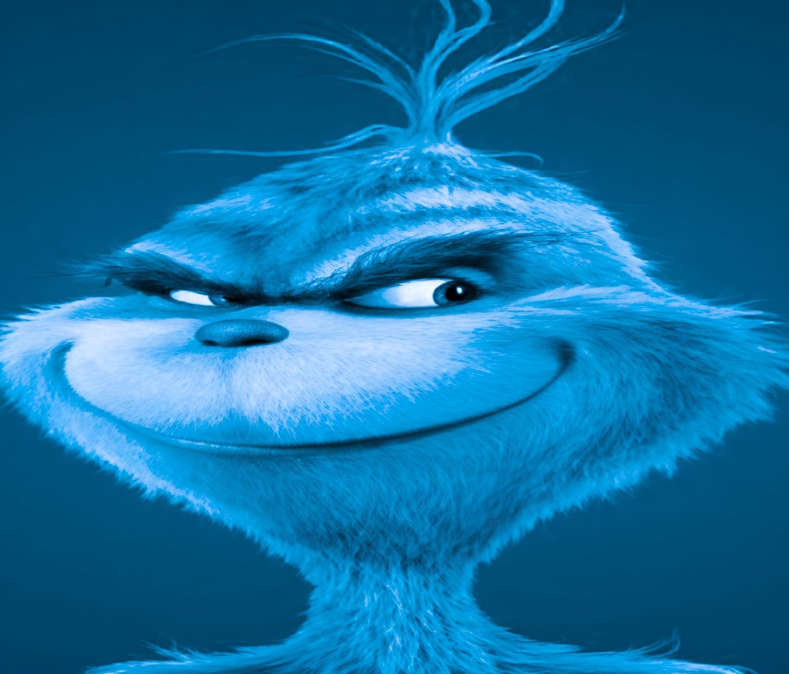 A close-up of a furry cartoon character (the Grinch) tinted entirely in blue against a solid blue background. The character has a wide sly smile, heavy lidded eyes looking sideways, thick furrowed brows, a small dark nose, and a messy tuft of hair sticking straight up. The expression is smug and scheming.