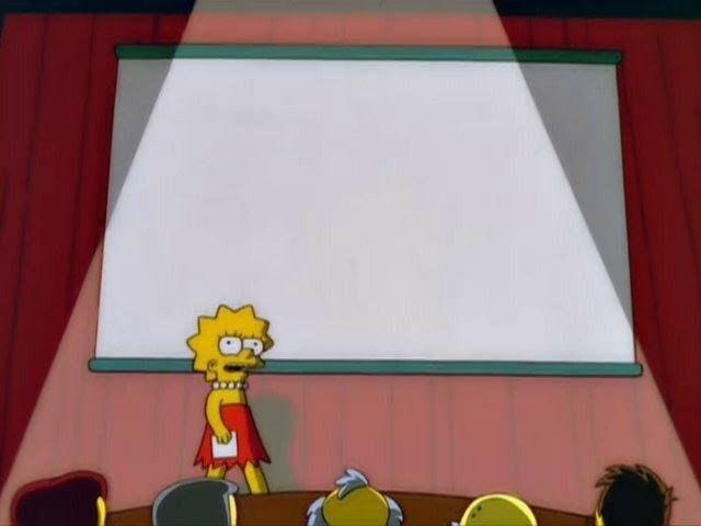 A yellow-skinned cartoon girl with star-shaped spiky hair stands at left in a short red dress, white pearl necklace, and white shoes. She holds a sheet of paper and faces the audience with wide eyes and an open mouth. Behind her is a large blank white projector screen with a teal-green frame, lit by a spotlight. Red stage curtains hang on both sides. In the foreground, the backs of several seated audience members’ heads are visible at a brown table.